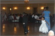 The flower girl chasing the ring bearer